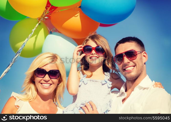 summer holidays, celebration, children and people concept - happy family with colorful balloons outdoors