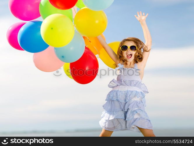 summer holidays, celebration, children and people concept - happy jumping girl with colorful balloons outdoors