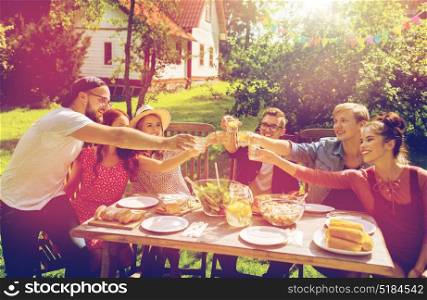 summer, holidays, celebration people and food concept - happy friends having garden party and clinking glasses. happy friends having party at summer garden