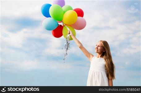 summer holidays, childhood and people concept - happy girl in sunglasses with air balloons outdoors. happy girl in sunglasses with air balloons