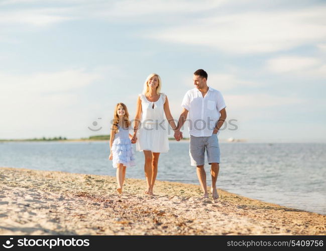 summer holidays, children and people concept - happy family at the seaside