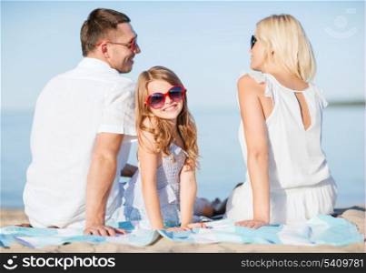 summer holidays, children and people concept - happy family on the beach