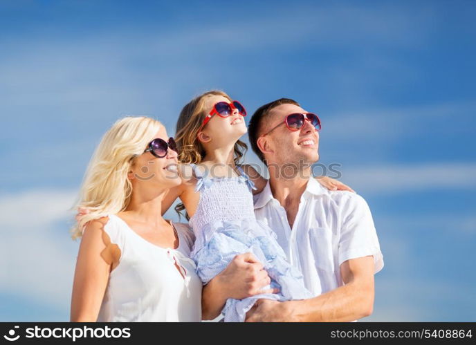 summer holidays, children and people concept - happy family with blue sky