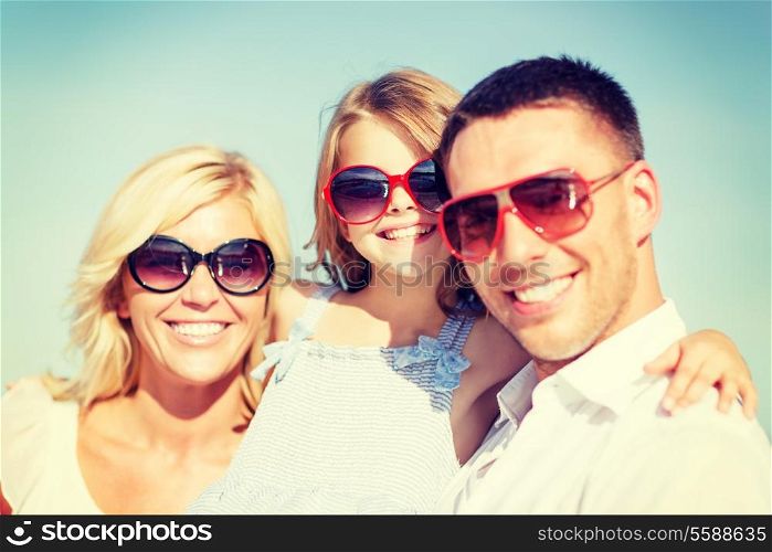 summer holidays, children and people concept - happy family with blue sky