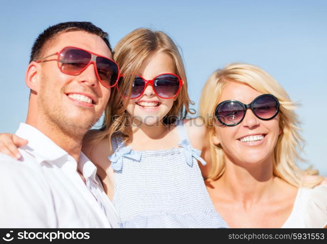 summer holidays, children and people concept - happy family with blue sky