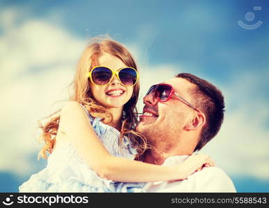 summer holidays, children and people concept - happy father and child in sunglasses over blue sky