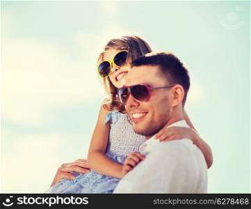summer holidays, children and people concept - happy father and child in sunglasses over blue sky