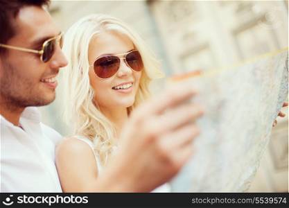summer holidays, dating and tourism concept - couple with map in the city