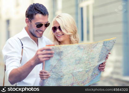 summer holidays, dating and tourism concept - smiling couple in sunglasses with map in the city