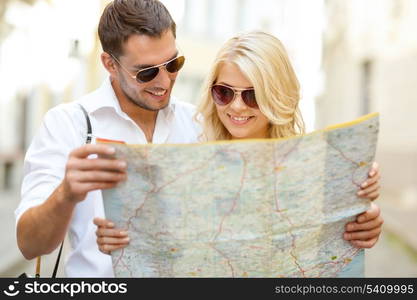 summer holidays, dating and tourism concept - smiling couple in sunglasses with map in the city