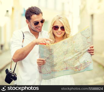 summer holidays, dating and tourism concept - smiling couple in sunglasses with map in the city