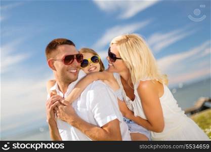 summer holidays, family, children and people concept - happy family in sunglasses having fun outdoors