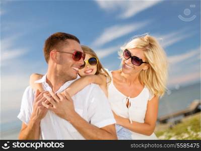 summer holidays, family, children and people concept - happy family in sunglasses having fun outdoors