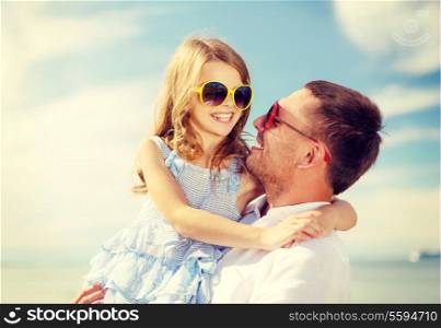 summer holidays, family, children and people concept - happy father and child girl having fun outdoors