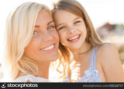 summer holidays, family, children and people concept - happy mother and child girl outdoors