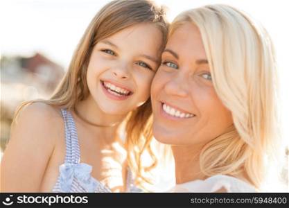 summer holidays, family, children and people concept - happy mother and child girl outdoors