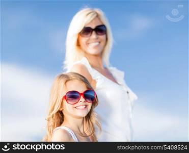 summer holidays, family, children and people concept - mother and child in sunglasses
