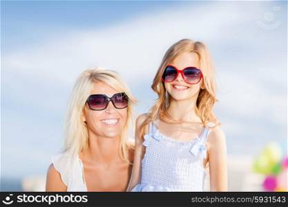 summer holidays, family, children and people concept - mother and child in sunglasses