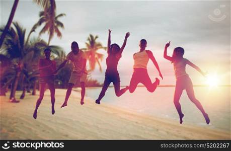 summer holidays, fun and people concept - group of happy friends dancing and jumping over exotic tropical beach with palm trees background. happy friends dancing and jumping on beach