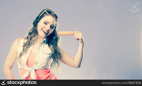 Summer holidays happiness concept. Happy joyful and cheerful young woman female model eating popsicle ice pop cross filter