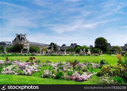 Summer holidays in Paris. Tuileries gardens in front of Louvre palace, Paris France.. Tuileries garden, Paris