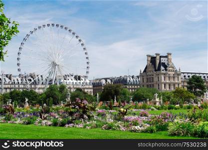 Summer holidays in Paris. Tuileries gardens with ferry wheel in front of Louvre palace, Paris France.. Tuileries garden, Paris