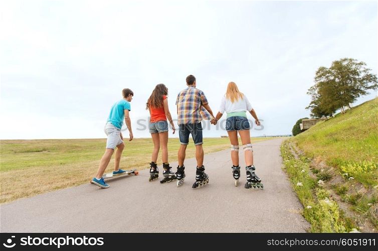 summer holidays, leisure, sport, love and people concept - group of teenage friends with rollerblades and longboards from back