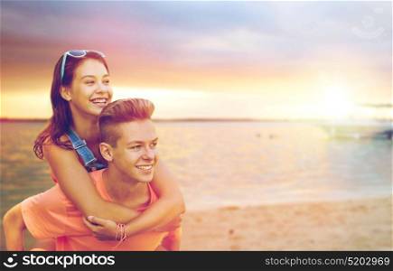 summer holidays, love and people concept - happy smiling teenage couple having fun over beach background. happy teenage couple having fun on beach