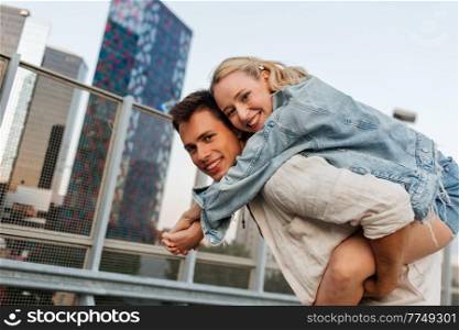 summer holidays, love and people concept - happy young couple having fun on roof top parking. happy young couple having fun on roof top parking
