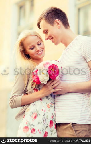 summer holidays, love, relationship and dating concept - couple with bouquet of flowers in the city