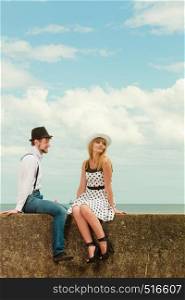 Summer holidays love relationship and dating concept - romantic playful couple retro style flirting on sea shore