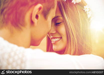 summer holidays, love, romance and people concept - happy smiling young hippie couple hugging outdoors