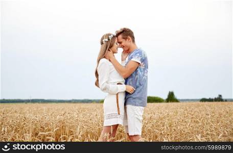 summer holidays, love, romance and people concept - happy smiling young hippie couple hugging outdoors