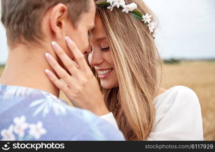 summer holidays, love, romance and people concept - happy smiling young hippie couple hugging outdoors