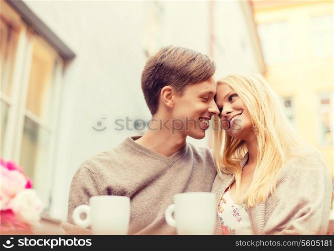 summer holidays, love, travel, relationship and dating concept - romantic happy couple in the cafe