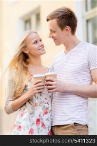 summer holidays, love, travel, tourism, relationship and dating concept - romantic couple in the city with takeaway coffee cups