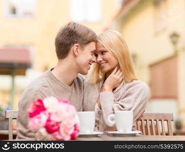 summer holidays, love, travel, tourism, relationship and dating concept - romantic happy couple kissing in the cafe