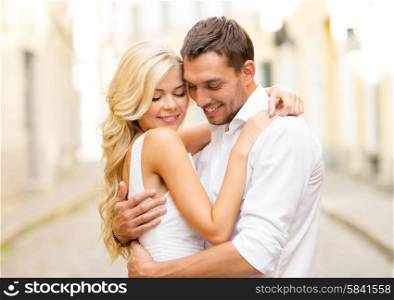 summer holidays, love, travel, tourism, relationship and dating concept - romantic happy couple hugging in the street