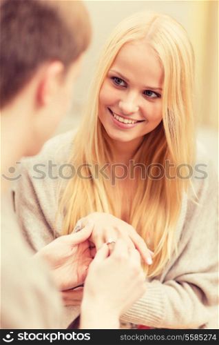 summer holidays, love, travel, tourism, relationship and dating concept - romantic man proposing to beautiful woman