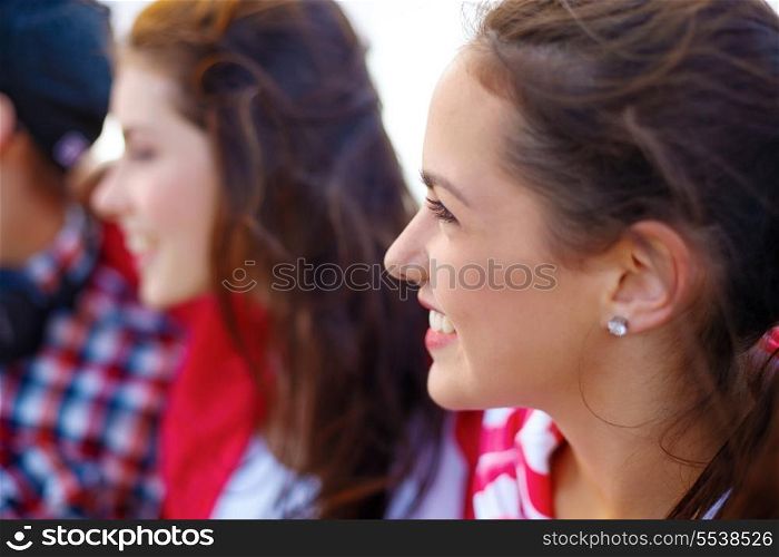 summer holidays, people and happiness concept - smiling teenage girl outdoors with friends