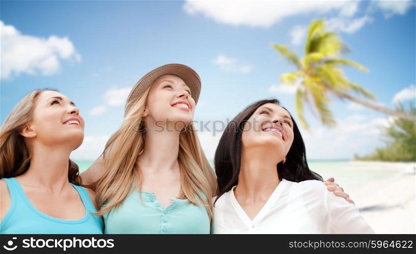 summer holidays, people, travel and vacation concept - group of smiling young women chilling over tropical beach background