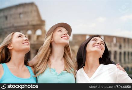 summer holidays, people, travel, tourism and vacation concept - group of smiling young women over coliseum in rome background