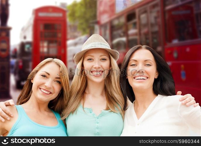 summer holidays, people, travel, tourism and vacation concept - group of smiling young women over london city street background