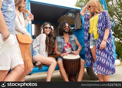 summer holidays, road trip, travel and people concept - happy young hippie friends with tom-tom drum having fun and playing music in minivan car. happy hippie friends playing music in minivan