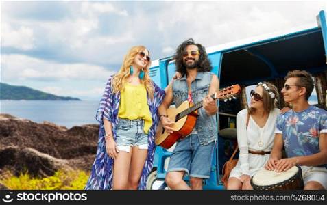 summer holidays, road trip, travel and people concept - happy young hippie friends with guitar and drum playing music at minivan car over island background. hippie friends playing music at minivan on island