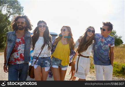 summer holidays, road trip, travel and people concept - smiling happy young hippie friends at minivan car. smiling happy young hippie friends at minivan car