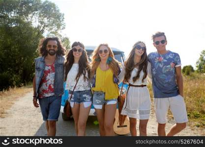 summer holidays, road trip, travel and people concept - smiling happy young hippie friends near minivan car. smiling happy young hippie friends and minivan car