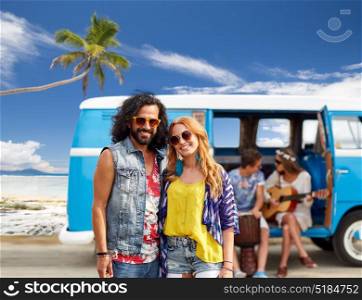 summer holidays, road trip, travel and people concept - smiling young hippie couple with friends in minivan car over beach background. happy hippie couples and minivan on beach