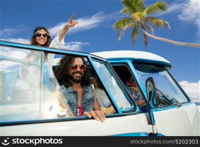 summer holidays, road trip, travel and people concept - smiling young hippie friends in minivan car over tropical beach background. happy hippie friends in minivan car on beach