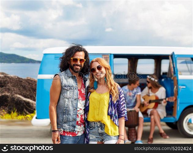 summer holidays, road trip, travel and people concept - smiling young hippie couple with friends in minivan car over island background. happy hippie couples and minivan on island